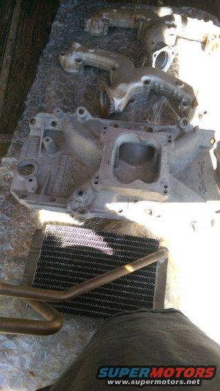 Engine intake manifold and a radiator are laid out on a surface