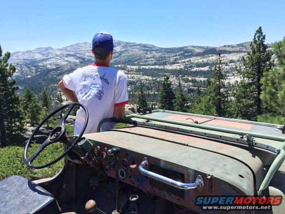 1946 Jeep CJ5 interior with steering wheel and dashboard, overlooking mountains