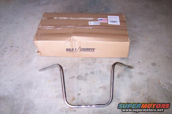 Chrome motorcycle handlebars in front of a cardboard box labeled WILD 1 CHUBBYS