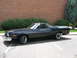 1973 Ford Ranchero - Side view of a black 1973 Ford Ranchero pickup truck parked in a lot.