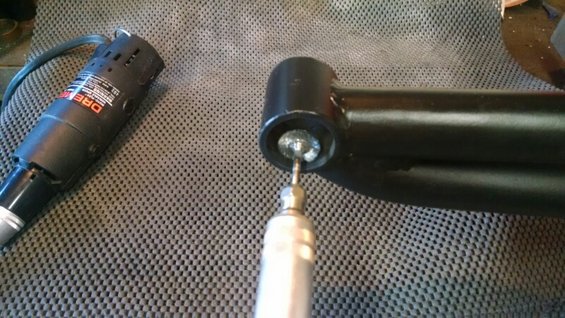 Rotary tool cleaning a black metal suspension component
