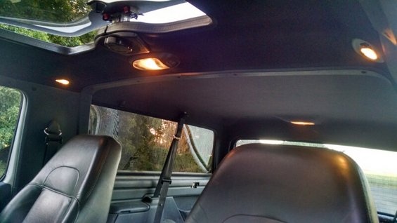 Interior view of a 1992 Ford Bronco showing front seats, sunroof, and dome lights