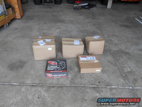 Several cardboard boxes and one open box showing a G2 aluminum differential cover