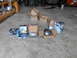 1992 Ford Bronco - Various automotive parts, including differential components, are arranged on a concrete surface in a garage setting.