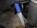 1992 Ford Bronco - Close-up view of a shock absorber with a blue protective boot and an adjacent air spring.