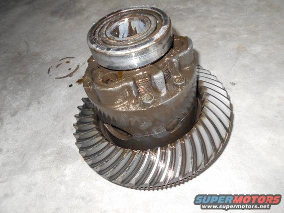 Differential gear assembly with a bearing on top, resting on a concrete surface