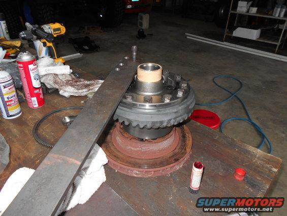 Differential assembly on a workbench with tools and spray cans
