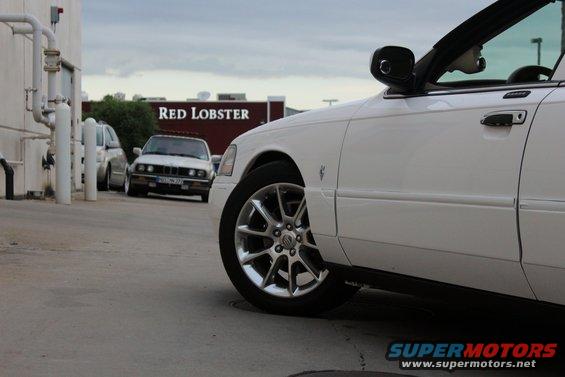 White sedan parked outside Red Lobster. Another car is visible in the background