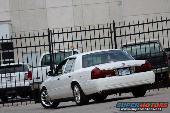 White 2000 Mercury Grand Marquis rear view with custom wheels