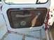 1970 Ford F-250 - The interior door panel of a 1970 Ford F-250 shows its ribbed texture and chrome window crank.