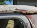 1970 Ford F-250 - Close-up of a heavily rusted white truck roofline, showing significant paint damage.