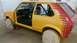 1983 Volkswagen Rabbit - Car is in a workshop with the door off and wheels covered.