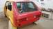 1983 Volkswagen Rabbit - Rear view of a red Volkswagen Golf Mk1 with yellow primer on the body, showing a roll cage and undergoing repairs.