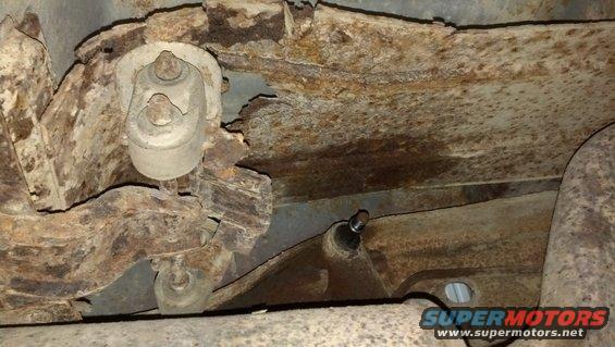 Muffler bracket is completely rusted away.