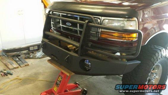 11214218_10206484023653429_4027151686681389314.jpg Using the floor jack to line up the new bumper