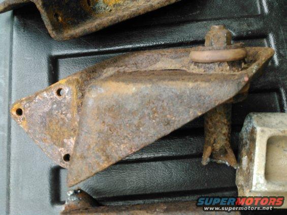 close-up of several rusty metal brackets and bolts