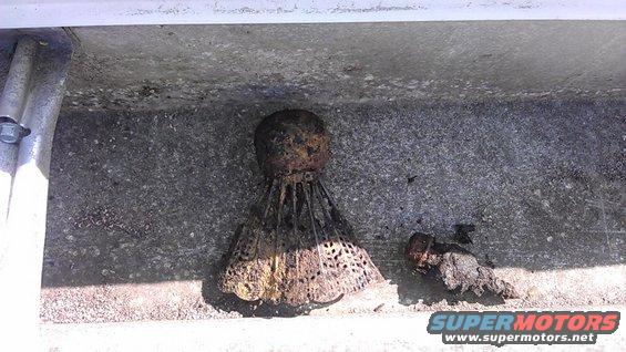 rusted shuttlecock and a bolt on concrete