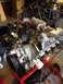 1978 Ford Bronco - A V8 engine is mounted on a stand, ready for installation or repair, with various garage items in the background.