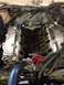 1978 Ford Bronco - Close-up view of an engine with chrome valve covers and the intake manifold removed, revealing internal components.