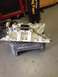 1978 Ford Bronco - Engine intake manifold with chain, possibly for an engine swap project.