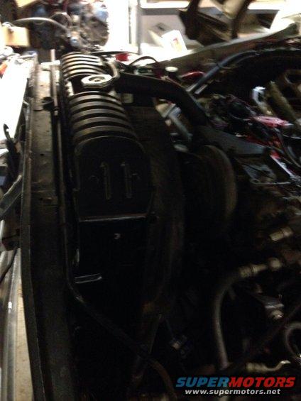 Radiator and engine bay of a vehicle, with visible wiring and hoses