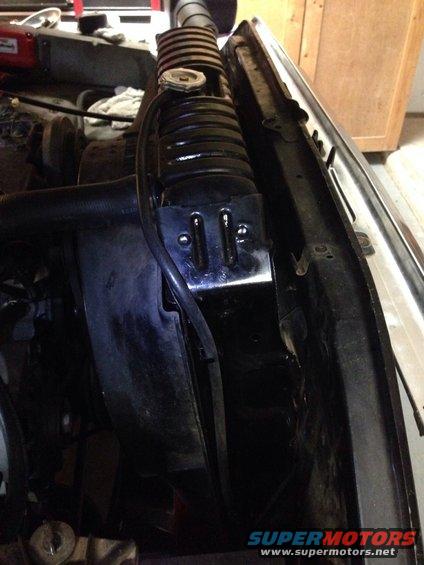 Radiator and hoses in engine bay. Watermark reads SUPERMOTORS.NET