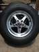 2004 Ford Crown Victoria - A close-up view of a chrome wheel and tire, with a visible Supermotors.net watermark.