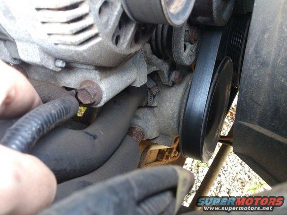 Close-up of an engine belt around an alternator pulley