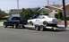 1970 Ford Maverick - 1970 Ford Maverick race car being transported on a trailer by a Dodge Ram pickup truck.