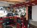 2004 Aston Martin Virage - A busy workshop is filled with tools, storage, and equipment, suggesting a space for projects and repairs.