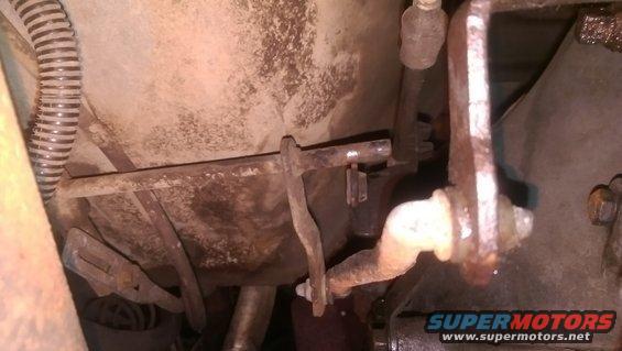 close-up of rusty linkage mechanism under a vehicle