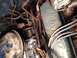 1973 Ford Bronco - Engine bay detail with carburetor and blue valve cover. Text on valve cover is partially visible.