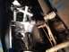 1973 Ford Bronco - Detail of engine components including carburetor and linkage, with visible signs of wear and rust.