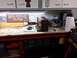2004 Aston Martin Virage - Workbench setup with various tools, signs, and cleaning equipment.