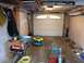 2004 Aston Martin Virage - A garage scene with various tools and equipment, including a table saw and a closed garage door.
