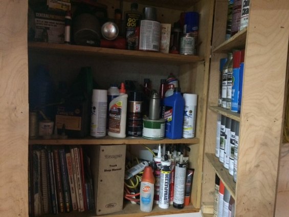 Shelving unit filled with bottles, cans, and books