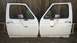 1994 Ford Bronco - Pair of white truck doors, likely for a Ford F-series or Bronco, displayed outdoors.