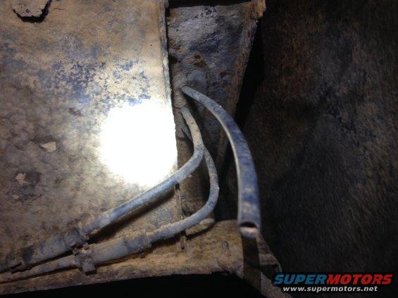 charcoal-can-2.jpg Lines & Hoses From Evap. Tank: Two Metal Lines that run along frame then turn to rubber hoses going up to the Driver's Rear Fender Well & 1 Rubber Hose Coming out of same fender well that has been cut but NOT plugged/capped!