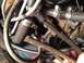 1973 Ford Bronco - A tangle of hoses and wires in a vehicle's engine compartment, showing signs of wear.
