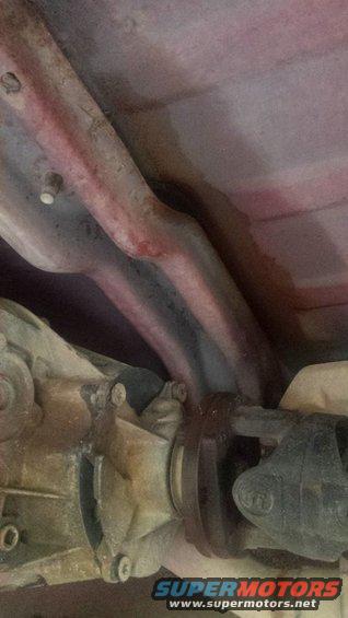 Undercarriage view of driveshaft and exhaust pipes