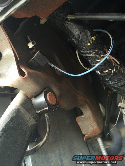 Close-up of vehicle's interior wiring and metal bracketry