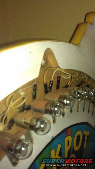 Pinball machine light bulbs and wiring with 'JPOT' graphic visible