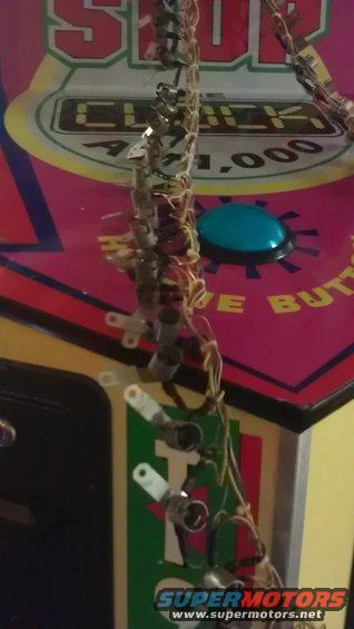 Pinball machine wiring with "STOP THE CLOCK" text and a blue button