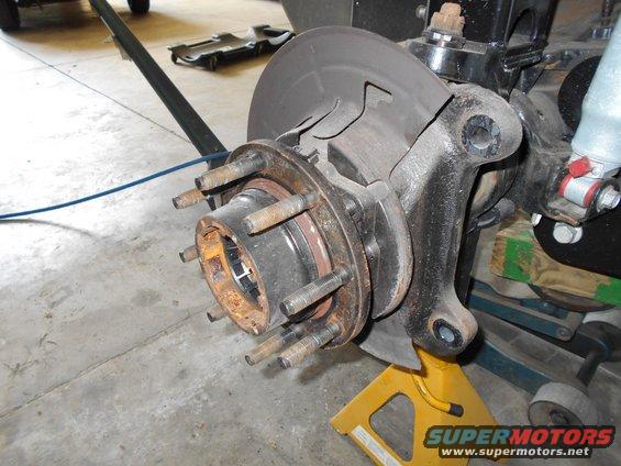 Front wheel hub assembly with brake rotor and caliper bracket