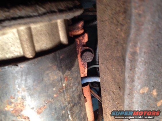 Close-up of rusty metal parts and bolts under a vehicle