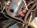 1973 Ford Bronco - Engine parts visible, including a blue valve cover and exhaust manifold. Supermotors.net logo in corner.