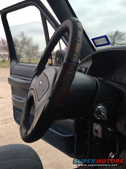 1993 Ford Bronco interior with leather-wrapped steering wheel and Texas inspection sticker