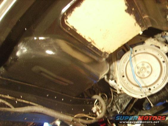 Underside view of engine and transmission bell housing with fuel lines