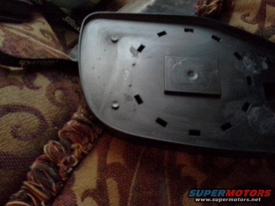 Back of black car side mirror with mounting holes