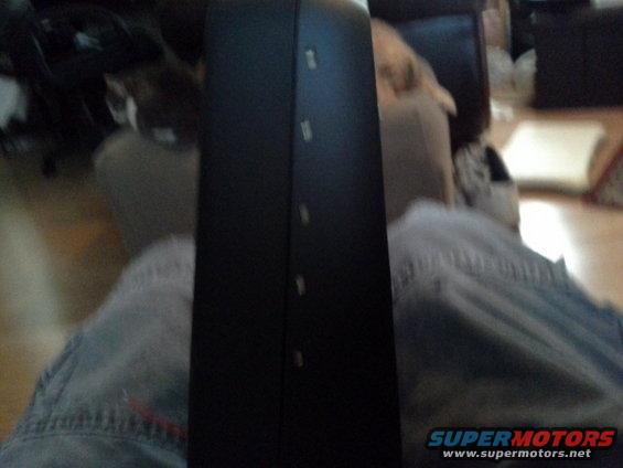 Black car interior panel with vertical buttons, possibly for windows or climate control